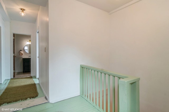 hallway with baseboards and wood finished floors
