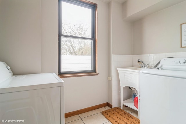 washroom featuring laundry area, light tile patterned flooring, and washer and dryer