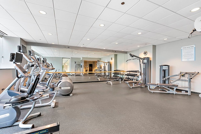 gym with recessed lighting and a paneled ceiling