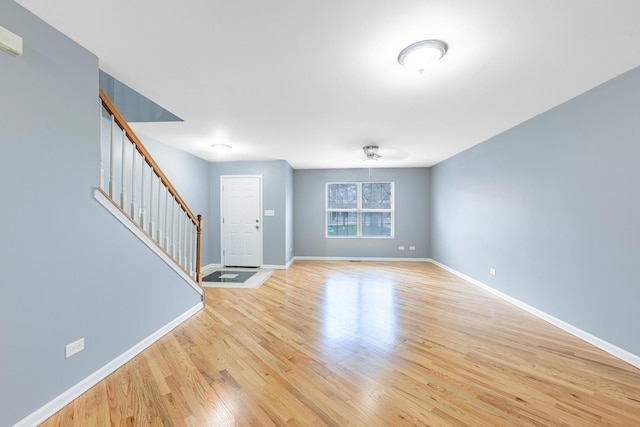 interior space with baseboards, light wood-style flooring, and stairs