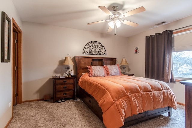 bedroom with light colored carpet, ceiling fan, baseboards, and visible vents