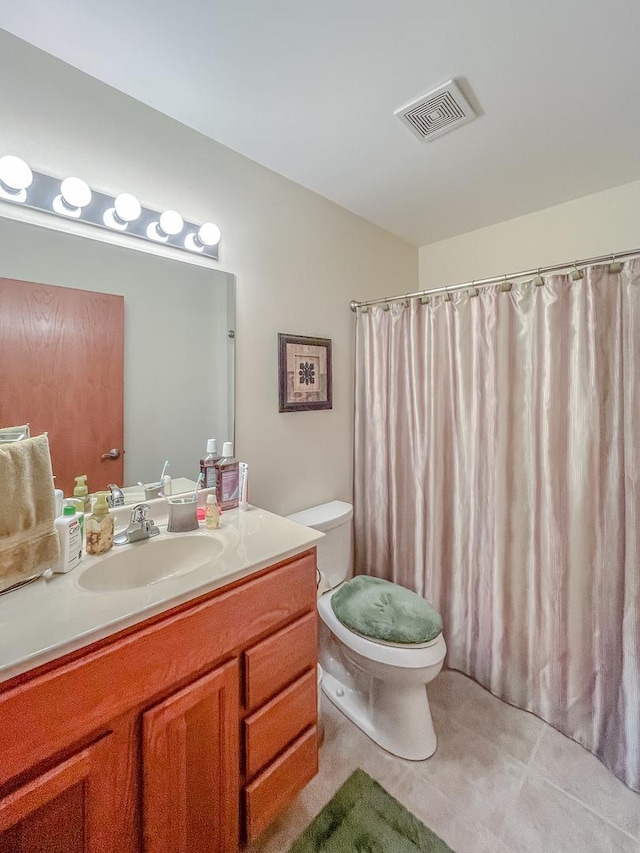 bathroom with visible vents, toilet, and vanity