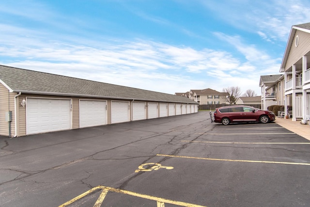 view of vehicle parking with community garages