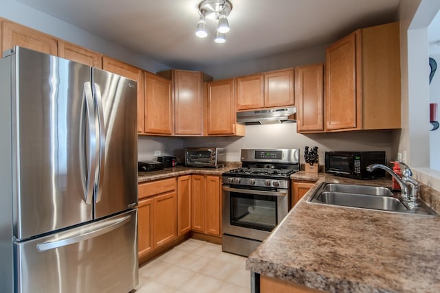 kitchen with a sink, a toaster, stainless steel appliances, light countertops, and under cabinet range hood