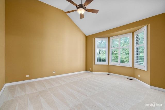 empty room featuring a ceiling fan, light colored carpet, lofted ceiling, and baseboards