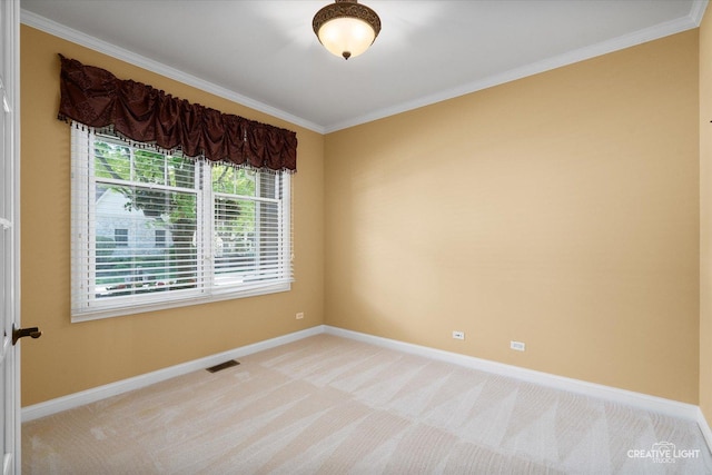 unfurnished room with baseboards, ornamental molding, and light colored carpet