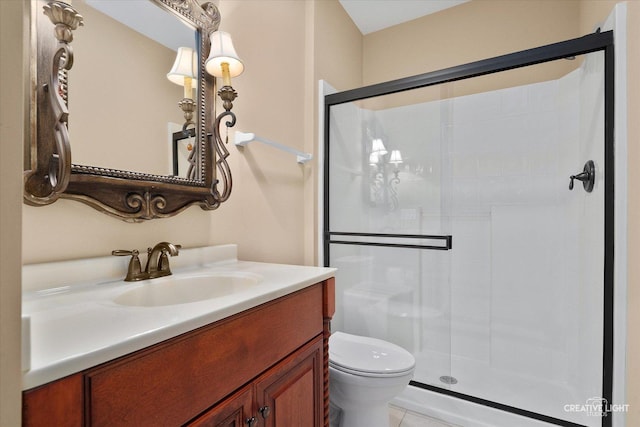 bathroom featuring a stall shower, toilet, and vanity