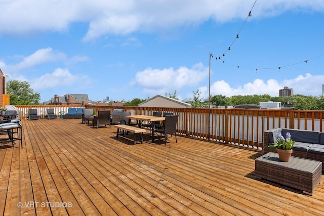wooden deck with outdoor dining area and an outdoor hangout area