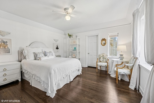 bedroom with ceiling fan and dark wood finished floors
