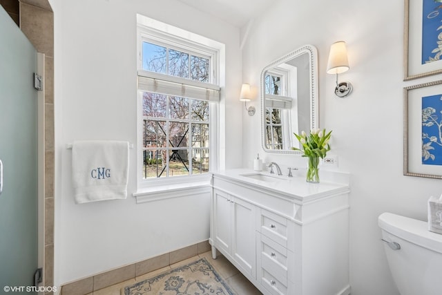 bathroom with tile patterned flooring, toilet, and vanity