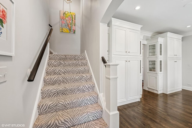 stairs with baseboards, recessed lighting, arched walkways, and wood finished floors