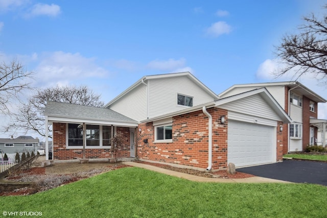 view of front of house featuring aphalt driveway, a front lawn, roof with shingles, an attached garage, and brick siding