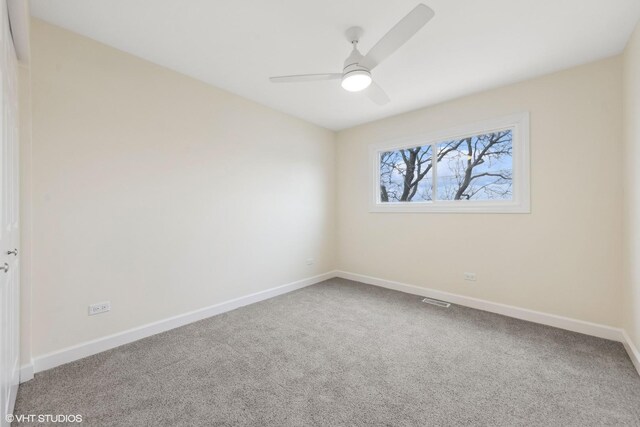 unfurnished room with visible vents, a ceiling fan, baseboards, and carpet