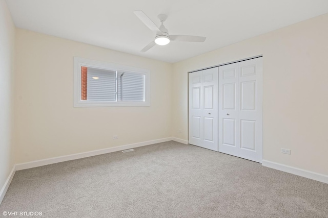 unfurnished bedroom with carpet floors, a closet, and baseboards