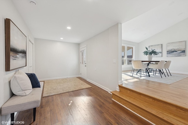 foyer with wood-type flooring, baseboards, lofted ceiling, and recessed lighting