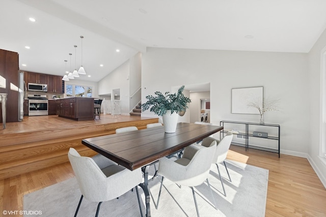 dining space with baseboards, stairs, light wood finished floors, and recessed lighting