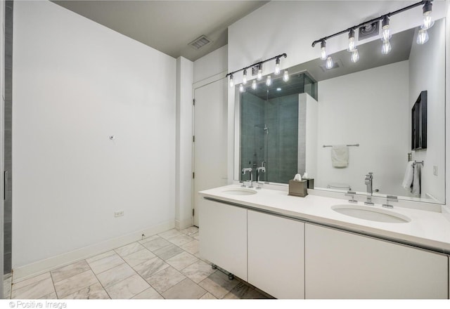 bathroom with marble finish floor, a sink, visible vents, and a stall shower