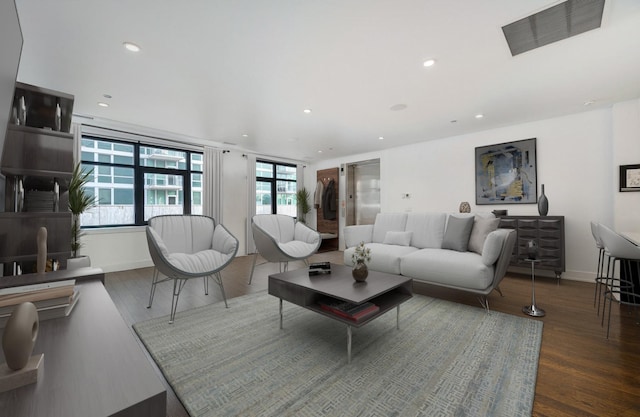 living room featuring recessed lighting, wood finished floors, and visible vents