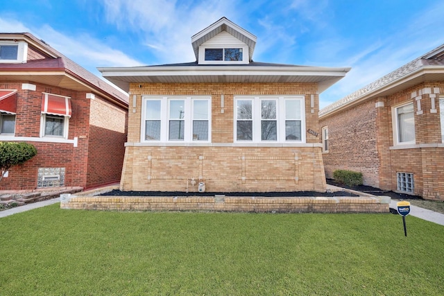 view of front of property featuring brick siding and a front yard