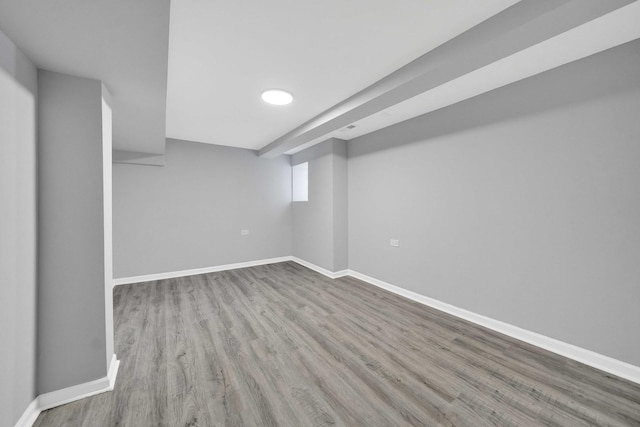 finished basement with baseboards and wood finished floors