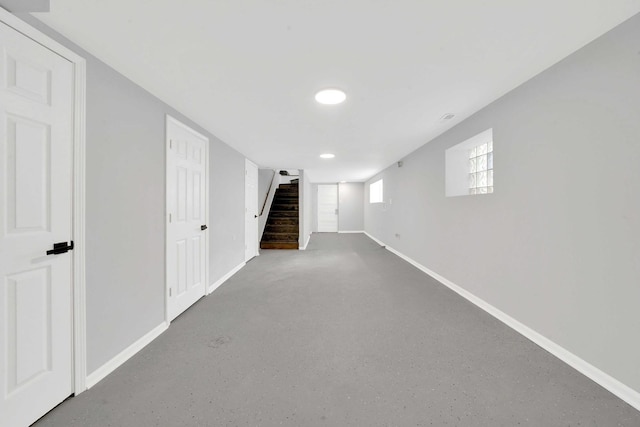 basement featuring stairway, baseboards, and recessed lighting