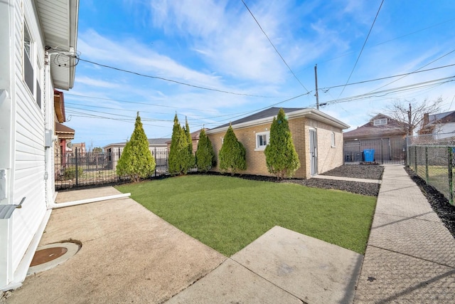 view of yard with an outdoor structure, a patio area, and a fenced backyard
