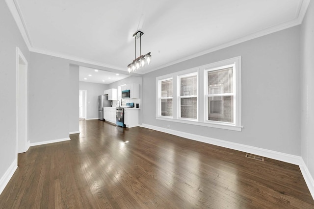 unfurnished living room with baseboards, visible vents, and crown molding