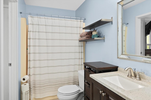 bathroom with toilet, curtained shower, and vanity