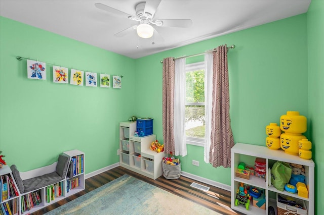 playroom with a ceiling fan, baseboards, visible vents, and wood finished floors