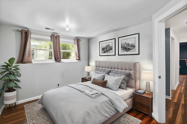 bedroom featuring baseboards, dark wood-style flooring, and visible vents