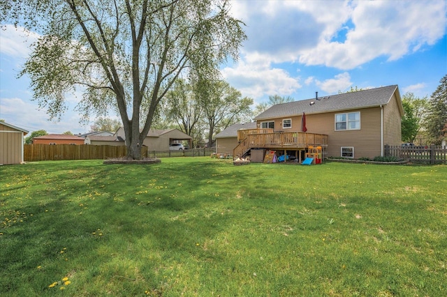 view of yard with a fenced backyard and a wooden deck