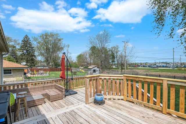 wooden deck with a yard and a fenced backyard