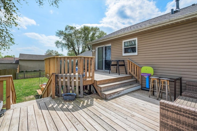 deck featuring a lawn and fence