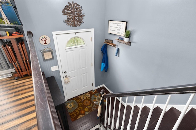 entryway featuring stairs, visible vents, and wood finished floors