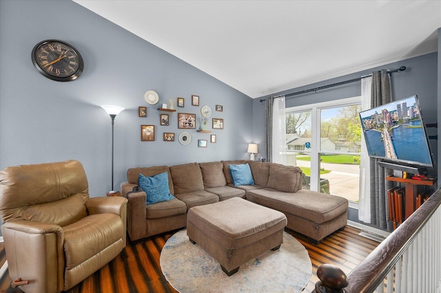 living area featuring wood finished floors and vaulted ceiling