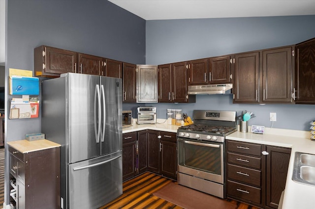 kitchen with light countertops, dark brown cabinetry, stainless steel appliances, and under cabinet range hood