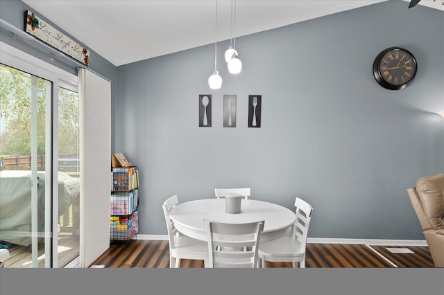 dining space featuring baseboards and wood finished floors