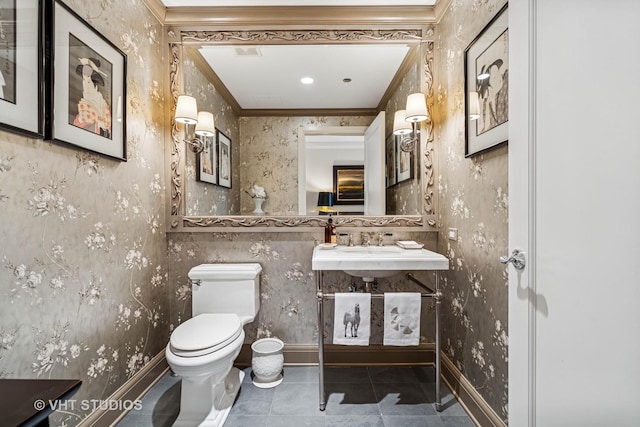 half bath featuring crown molding, toilet, baseboards, wallpapered walls, and tile patterned floors