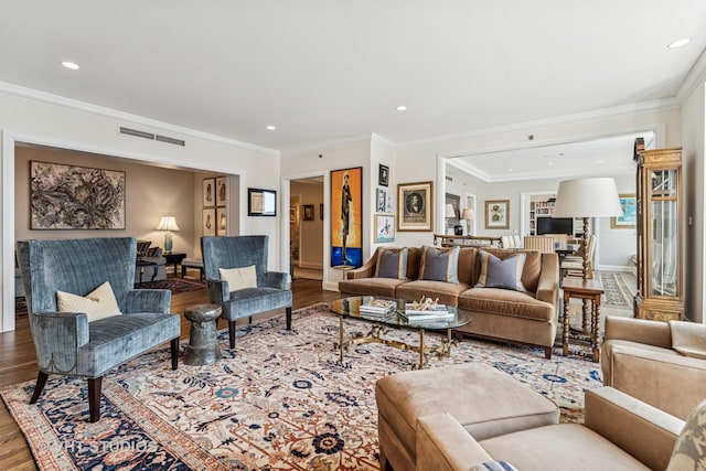 living area featuring ornamental molding, recessed lighting, and wood finished floors