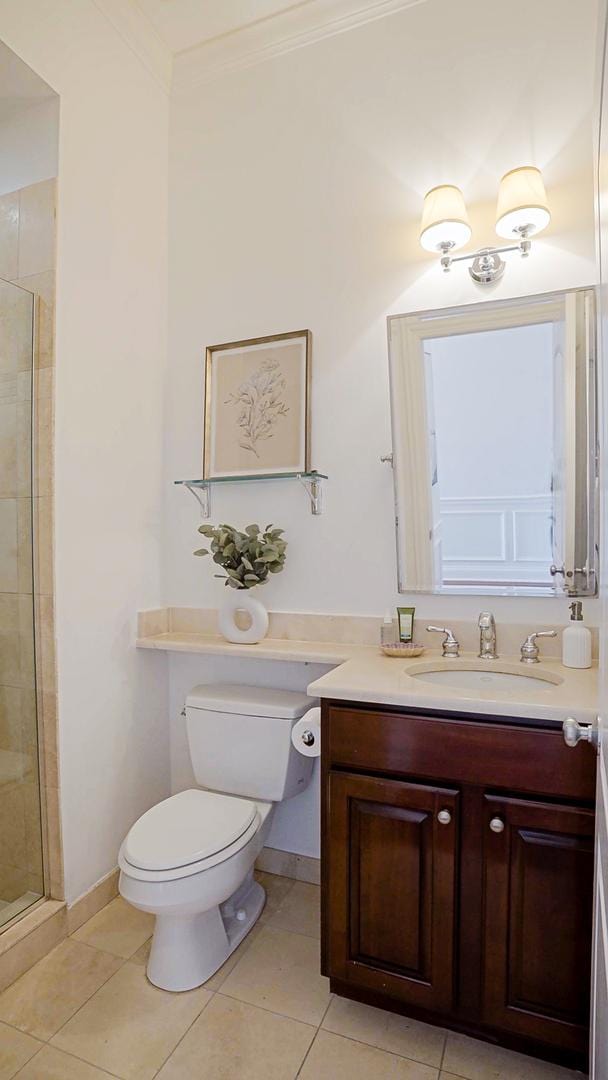 bathroom featuring ornamental molding, toilet, a shower stall, vanity, and tile patterned flooring