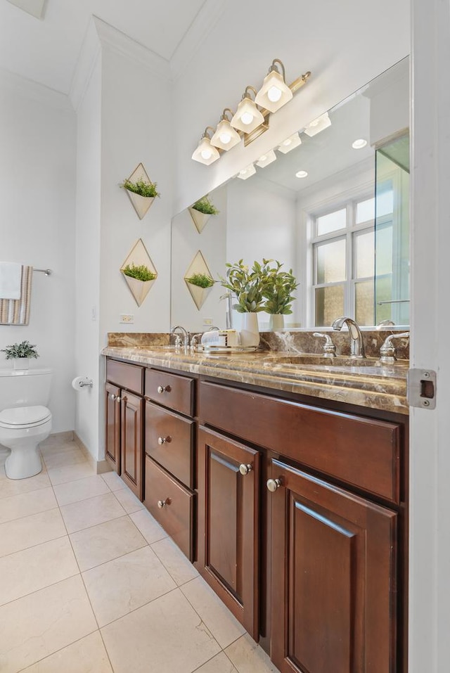 full bathroom with ornamental molding, double vanity, toilet, and tile patterned flooring