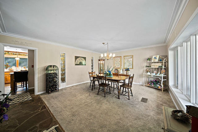 dining room with baseboards, ornamental molding, an inviting chandelier, and visible vents