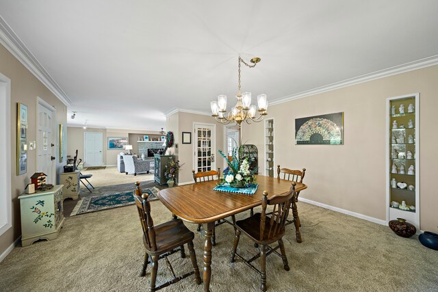 dining area featuring ornamental molding, a notable chandelier, and carpet floors