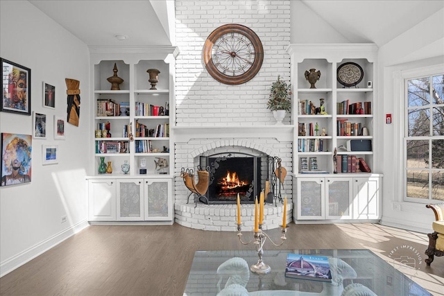 1651 Eagle Brook Dr, Geneva, IL 60134 - living room with vaulted ceiling, wood finished floors, a brick fireplace, and baseboards