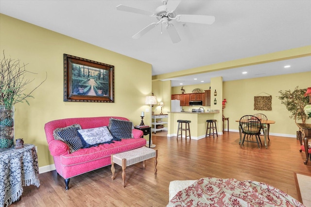 living room with baseboards, ceiling fan, recessed lighting, and wood finished floors