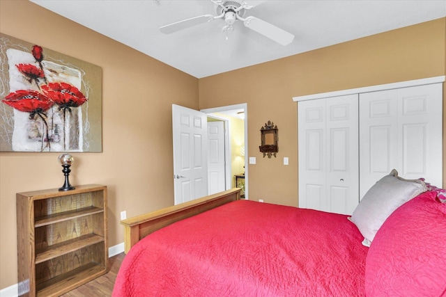 bedroom featuring a ceiling fan, baseboards, wood finished floors, and a closet