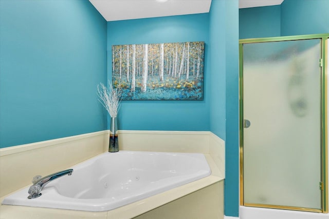 full bathroom featuring a shower stall and a jetted tub