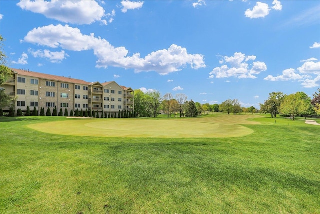 surrounding community with a lawn and golf course view