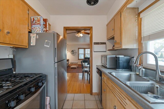 418 Bonnie Brae Ave, Itasca, IL 60143 - kitchen featuring a ceiling fan, light tile patterned floors, stainless steel appliances, and a sink