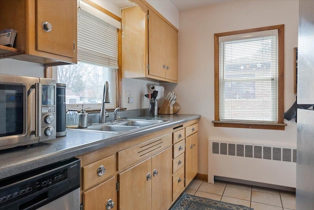 418 Bonnie Brae Ave, Itasca, IL 60143 - kitchen with stainless steel appliances, a sink, light tile patterned floors, and radiator